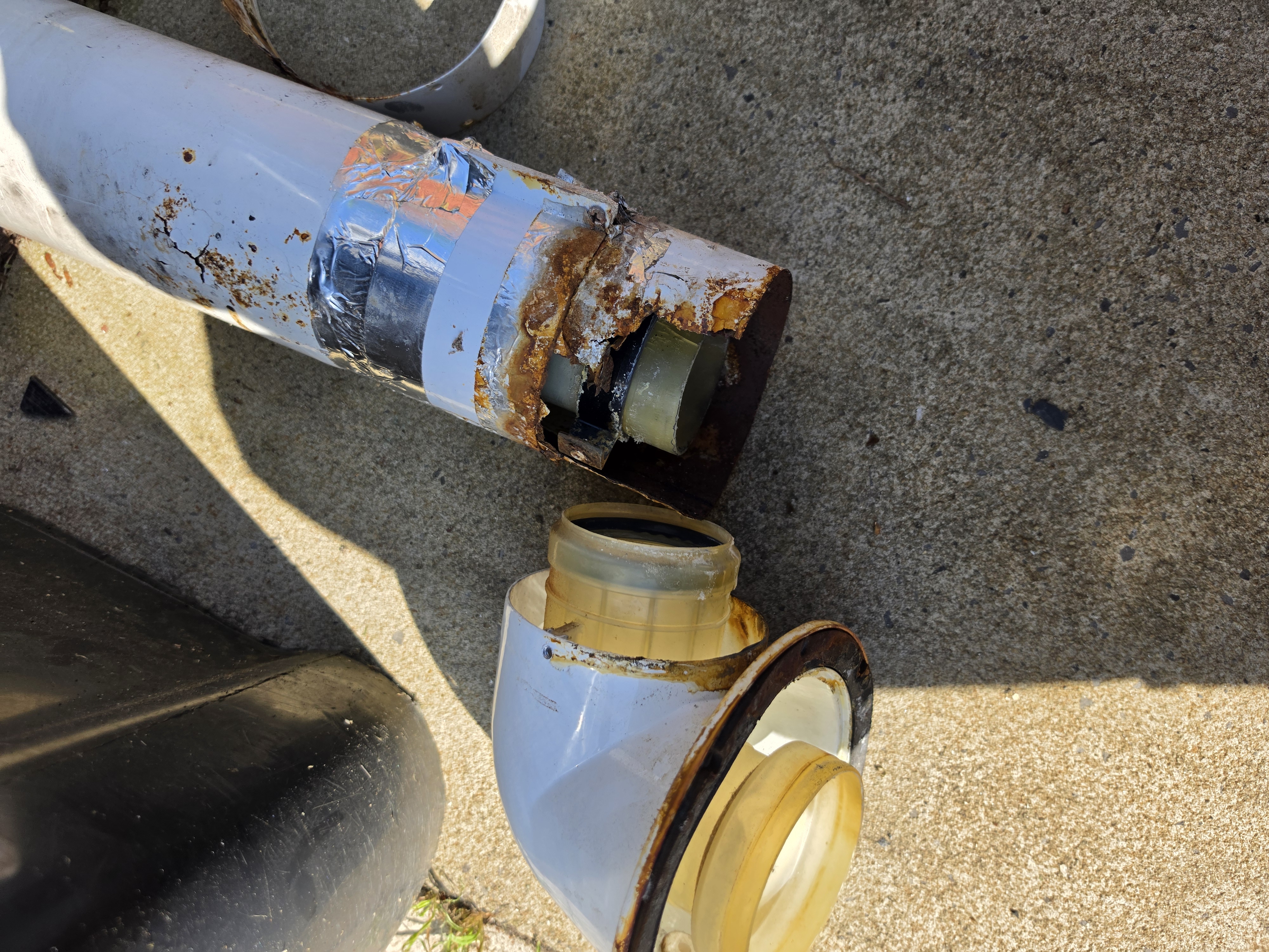 Completely rotted boiler flue held together with tape — dangerous and unsafe — real job photo Lewis Heating Wigan